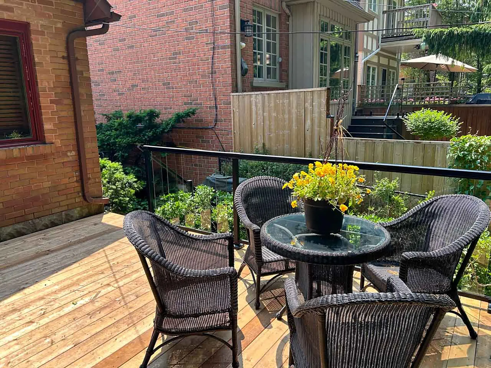 Interior-hero back deck with glass railings by Kerta Construction