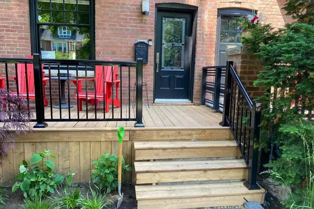 front deck with black railings by Kerta Construction