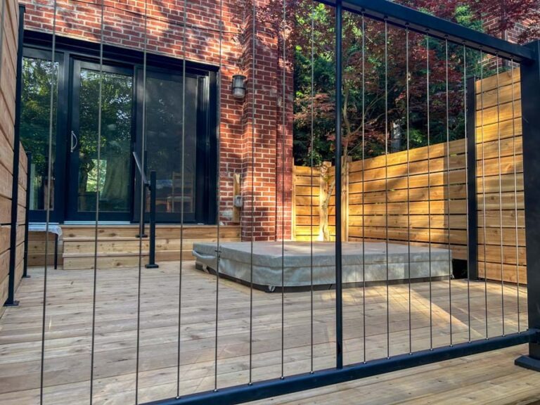 Landscape-Design-img6 view of hot tub built into deck through glass railing built by Kerta Construction