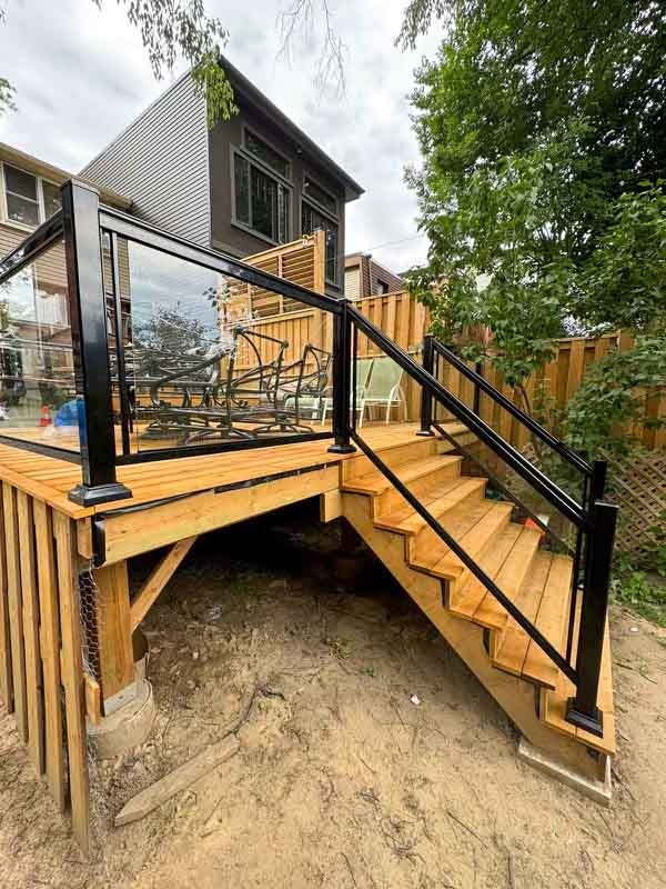 Outdoor-living-img5 multi tiered back deck with glass railings by Kerta Construction