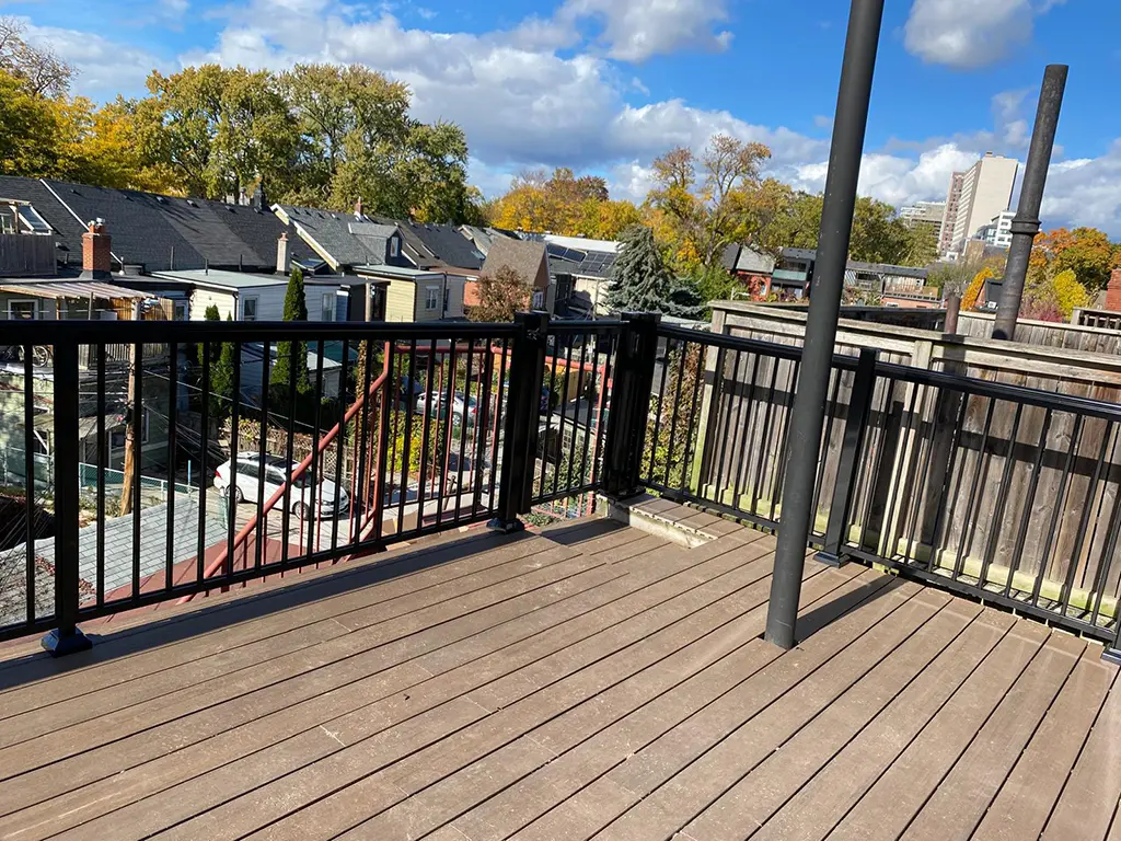Portfolio-img-40 deck with black railings in a city by Kerta Construction